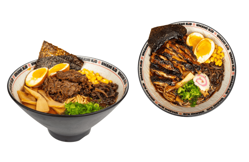 Two bowls of freshly prepared ramen from Umami Kid in Uptown Saint John, topped with soft-boiled eggs, grilled meat, corn, and seaweed in rich broth.