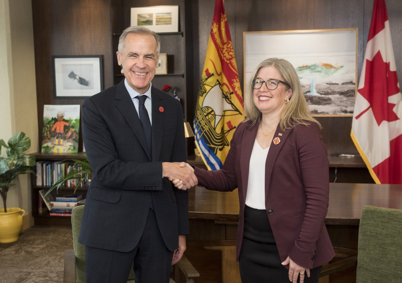 Prime Minister Mark Carney and New Brunswick Premier Susan Holt shake hands in Fredericton.