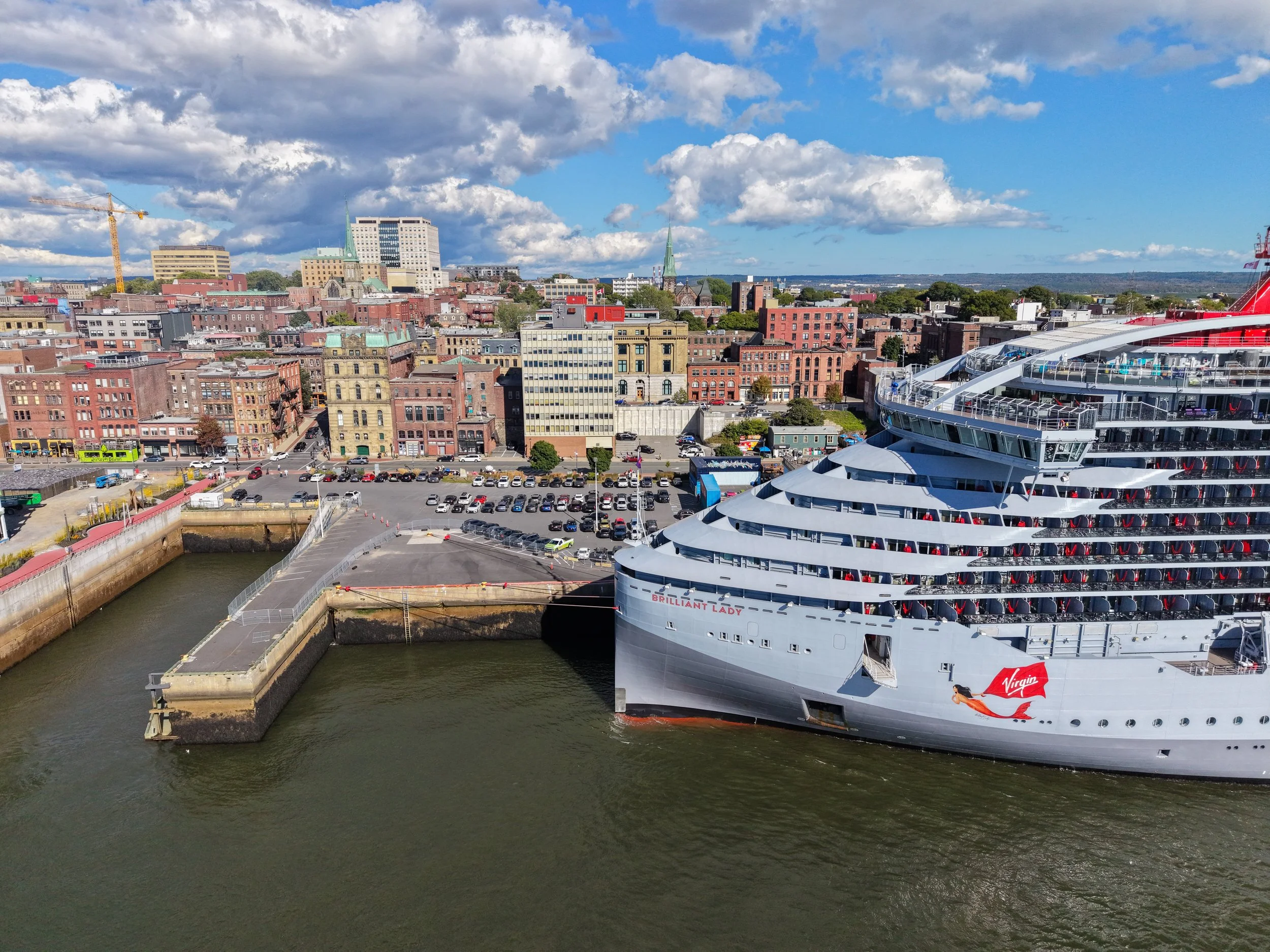 A cruise ship docked at Port Saint John with the city in the background.