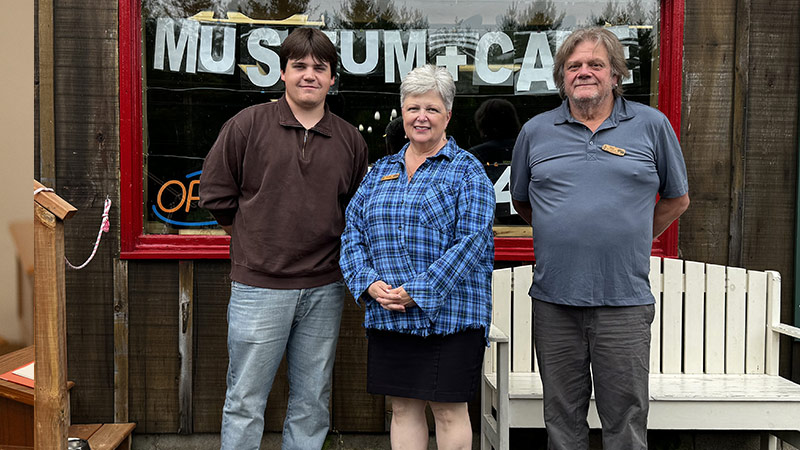 A student ambassador helps a community member with a laptop.