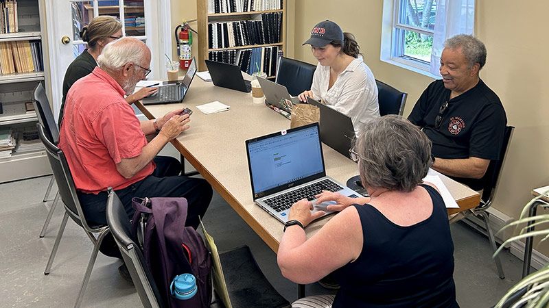 Project stakeholders and students gather for a meeting.