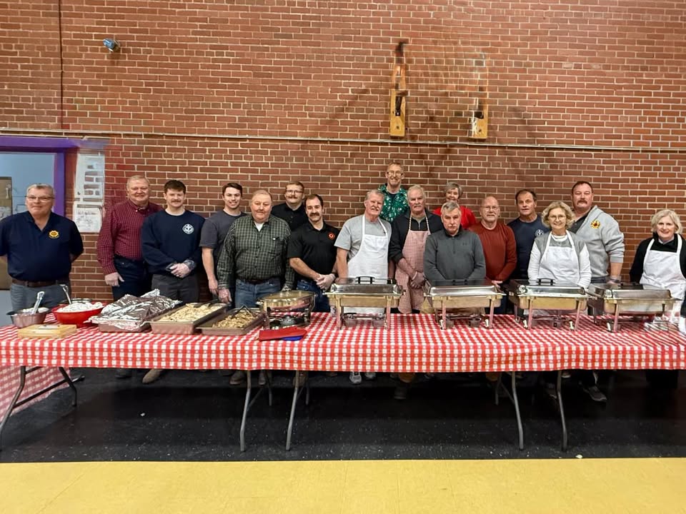 Volunteers serving food at the school lunch program.
