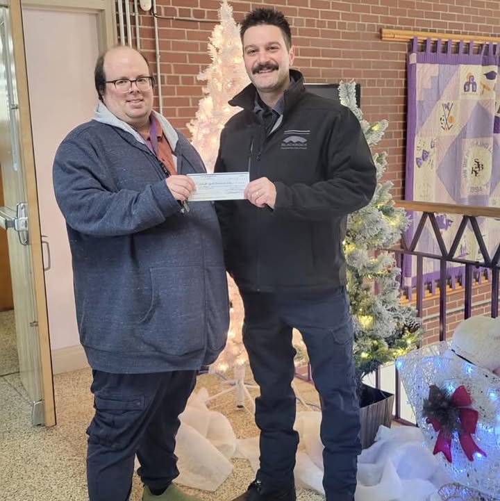 Local 771 President Tyler Embree delivers a donation.
