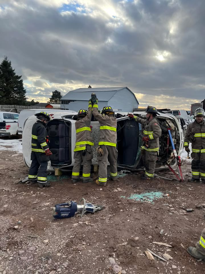 Saint John firefighters practice vehicle extrication on an overturned car.