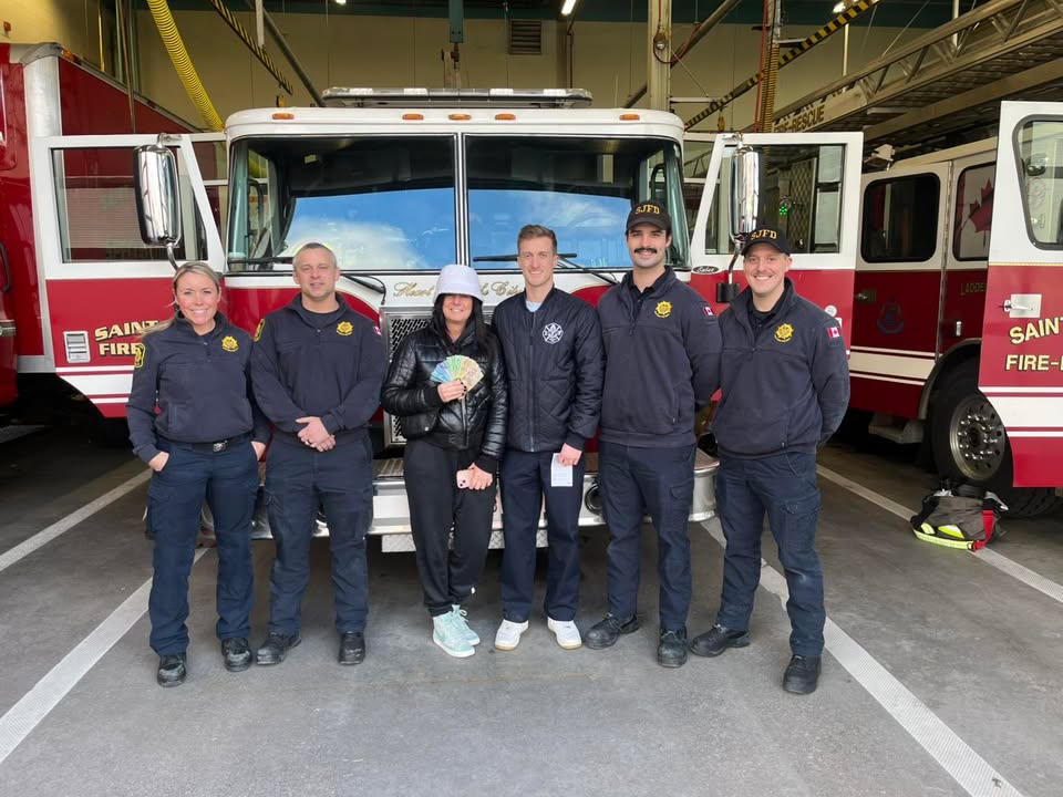 Saint John Firefighters holding a cheque for $17,300.