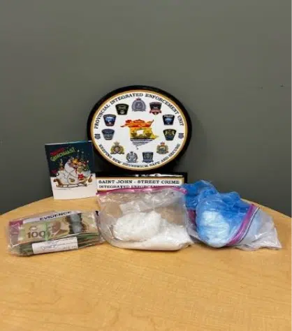 Evidence seized by Saint John Police including drugs, cash, and scales.