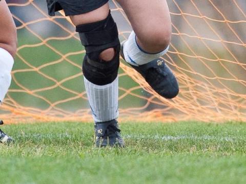 Sports equipment including balls and cones on a field