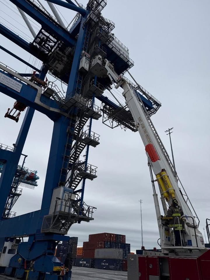 View from the ground of the ladder extended to the crane