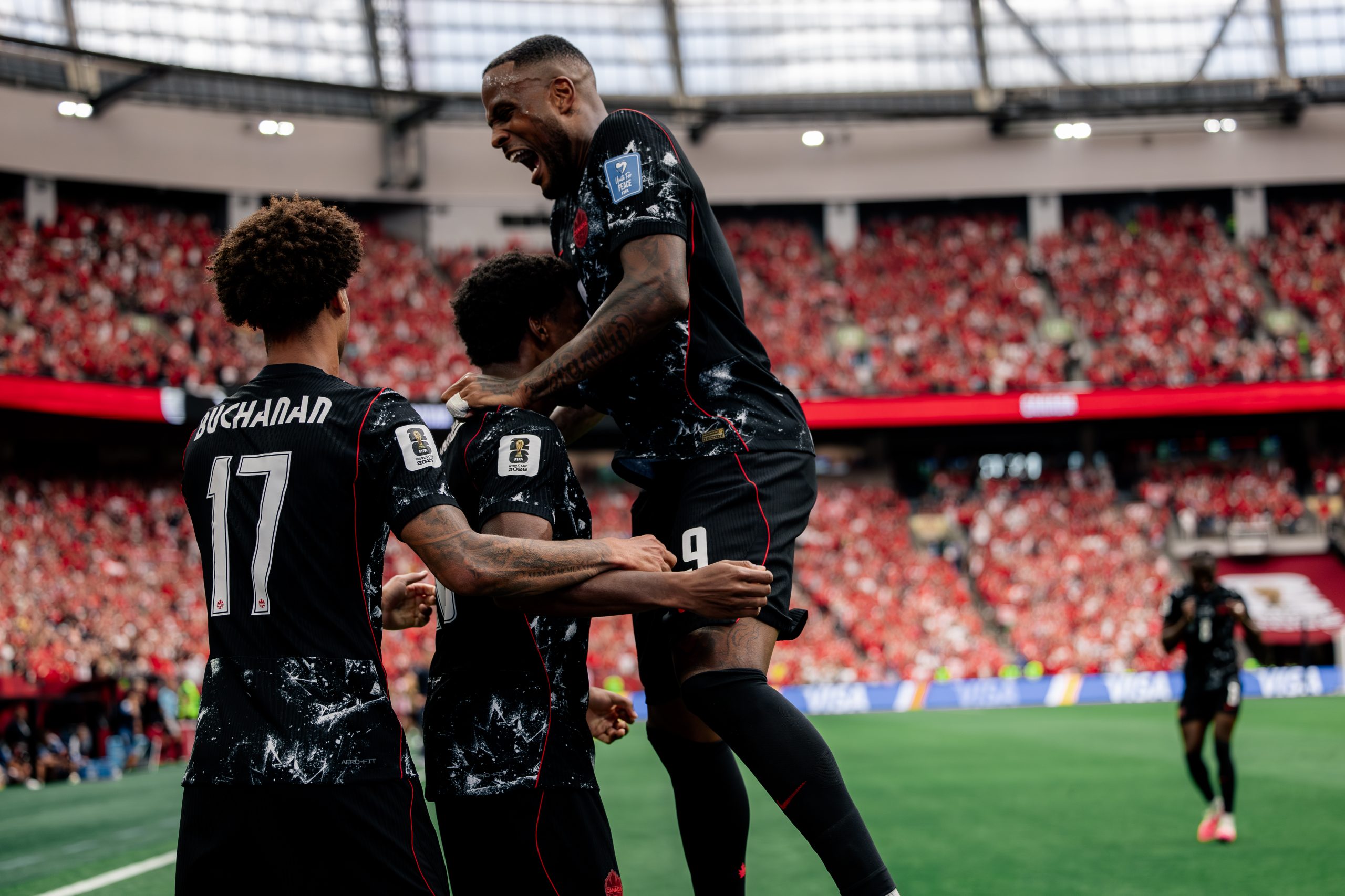Canada players celebrate after scoring a goal against Qatar