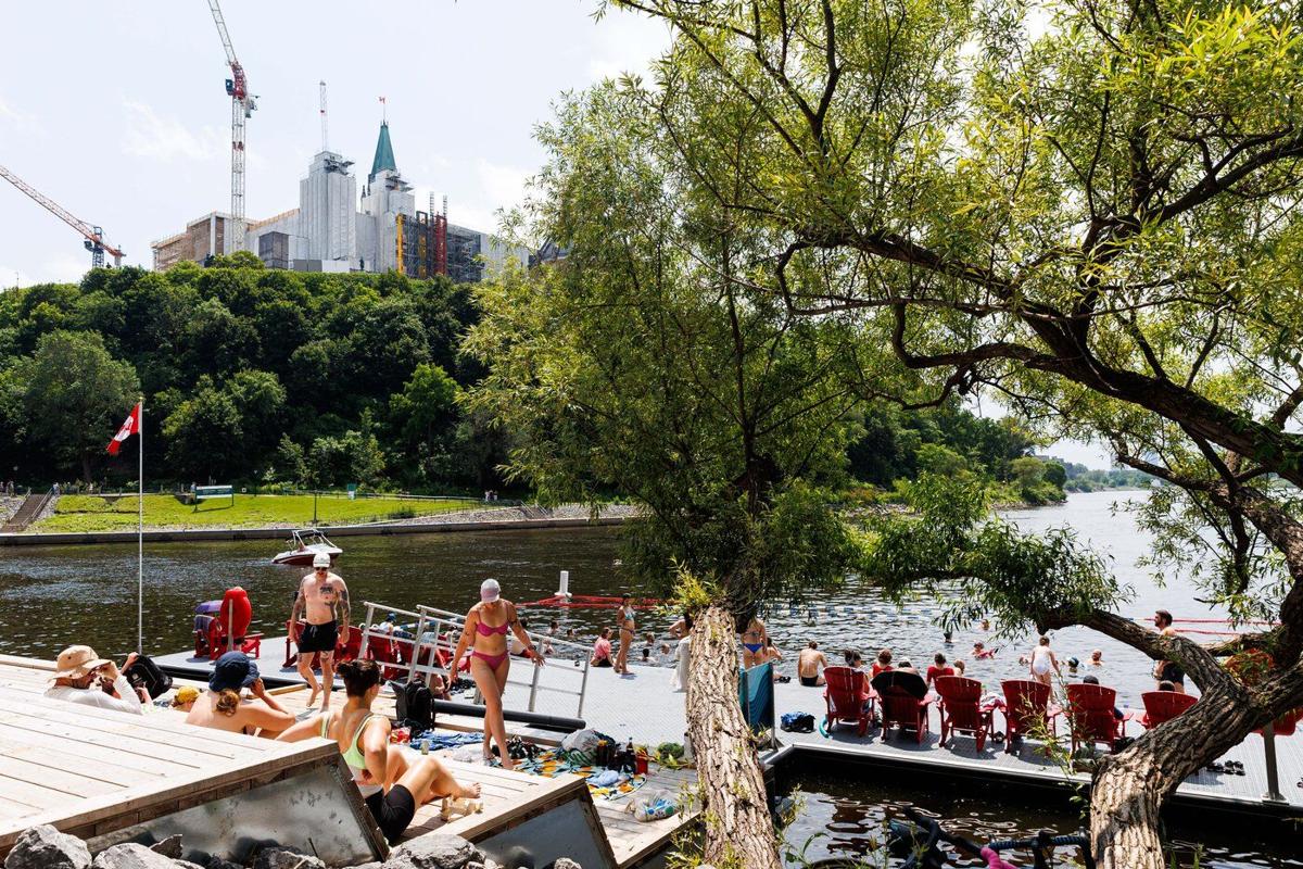 People cool off at the newly opened East Wharf Dock on Canada Day in Ottawa