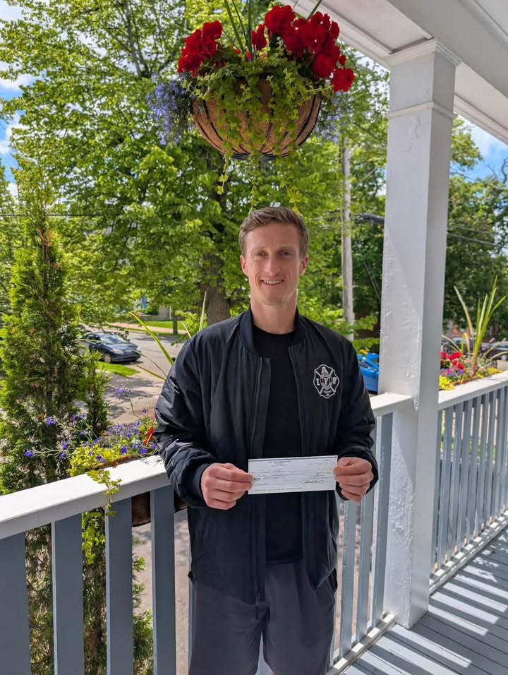 Saint John Firefighters presenting a donation check