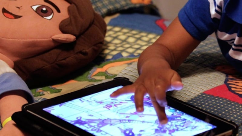 A child plays with an iPad