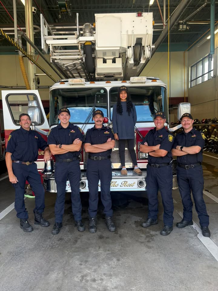 Olivia helping Saint John Firefighters