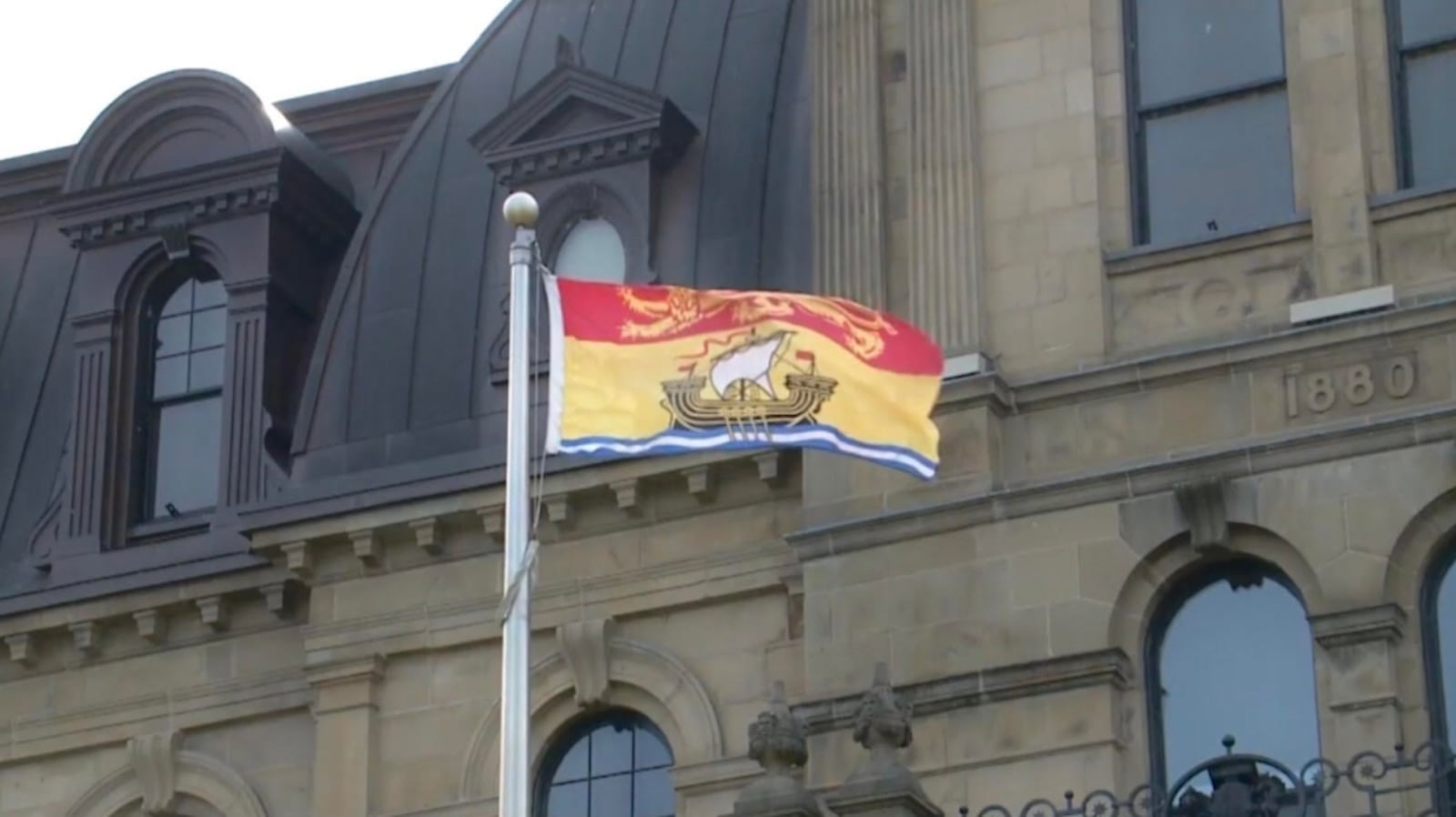 New Brunswick flag flying outside the provincial legislature in Fredericton