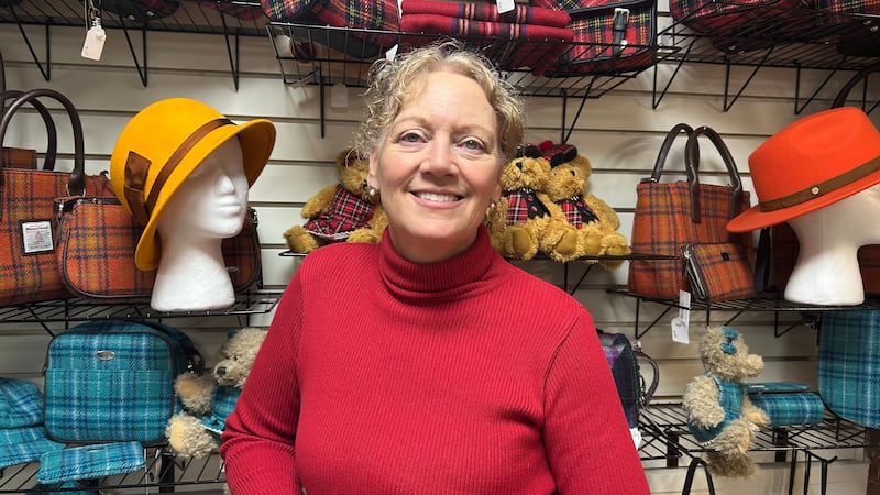 Susie Hines standing in her store Hats on the Square