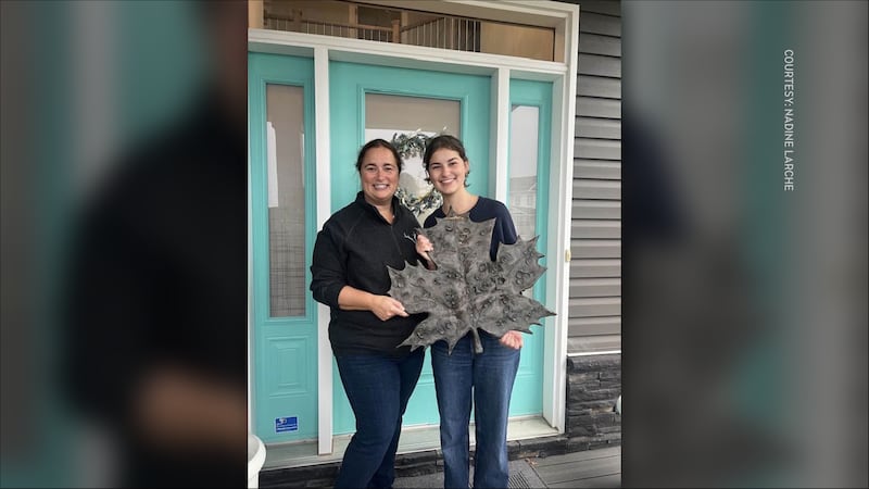 Nadine Larche with her daughter and the recovered bronze maple leaf