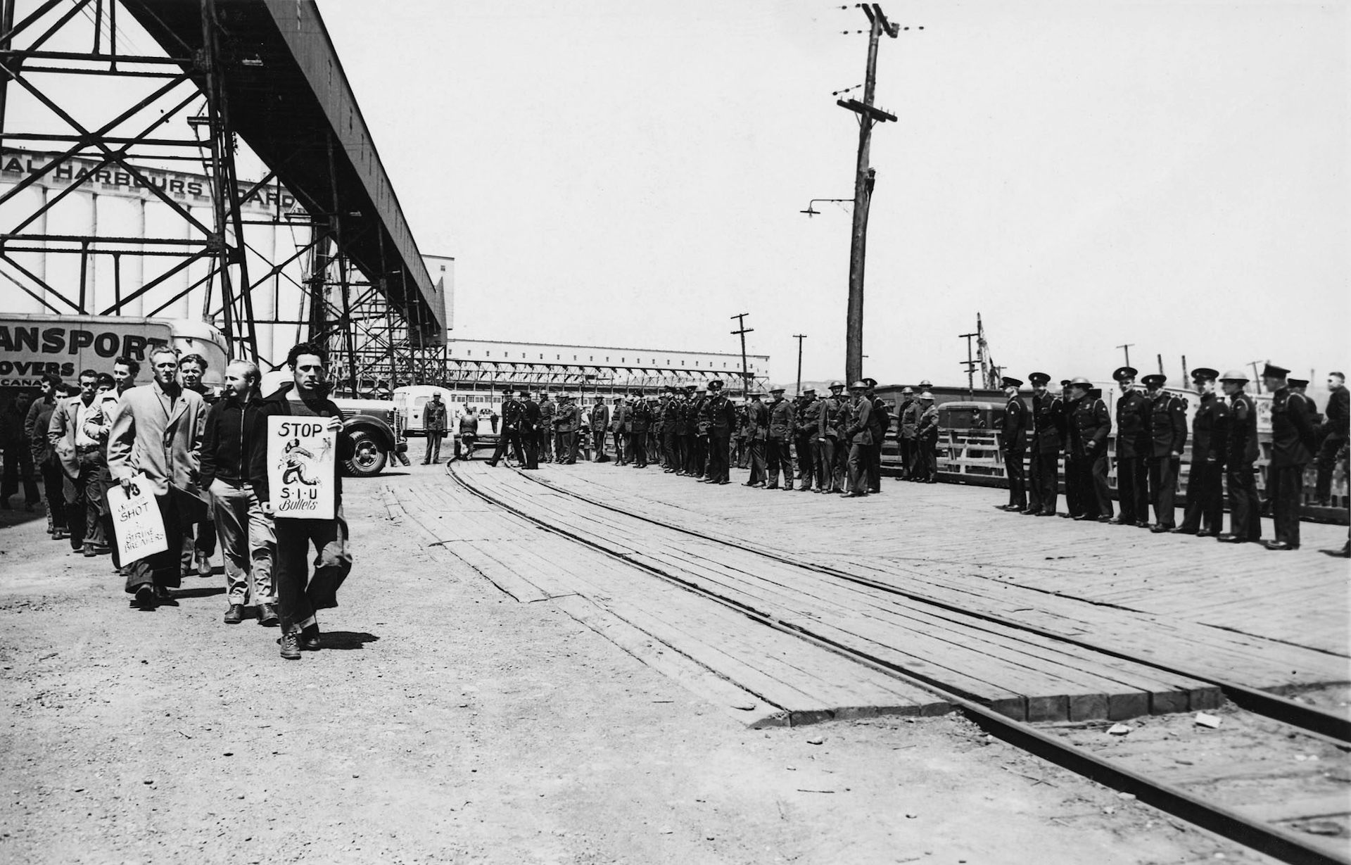 Police escort a replacement crew to the freighter Ottawa Valley in Saint John during a seamen strike in 1949